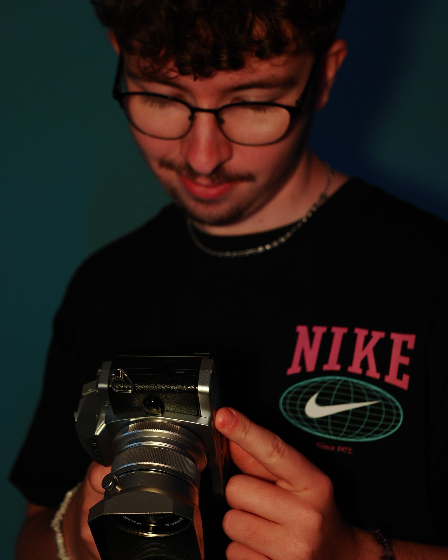 Person holding a camera with a dark background