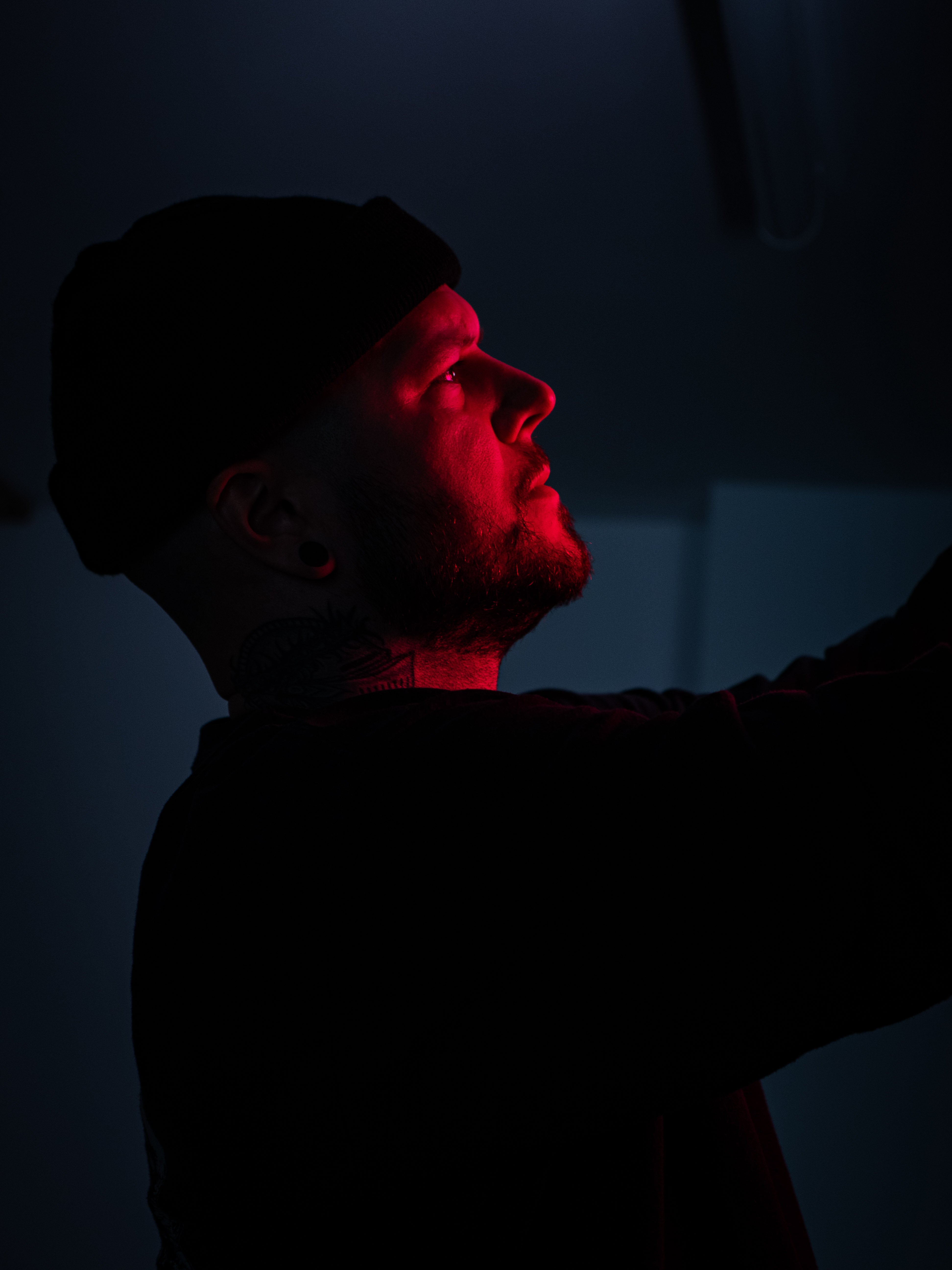 Person with red lighting on a dark background